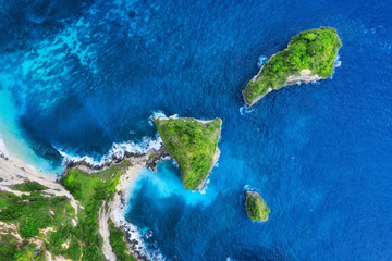 Wall Mural - aerial view at sea and rocks. turquoise water background from top view. summer seascape from air. at