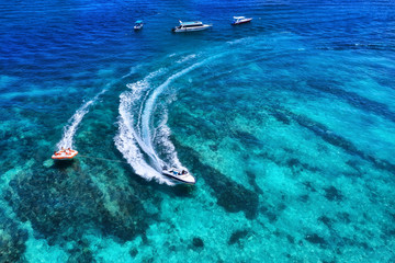 Wall Mural - yachts at the sea in bali, indonesia. aerial view of luxury floating boat on transparent turquoise w