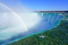 Rainbow Over The Horseshoe Falls Over Frozen Ice And Snow On The Niagara River In Niagara Falls In March 2019