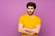 © luismolinero - Handsome over isolated purple wall feeling upset