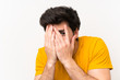 © luismolinero - Handsome over isolated white wall covering eyes and looking through fingers