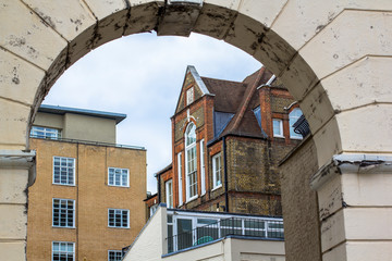 Wall Mural - Brick multi-level house with large beautiful windows. Picture taken through the old arch. Central London.