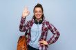 © luismolinero - Teenager student girl over isolated blue wall showing ok sign with fingers