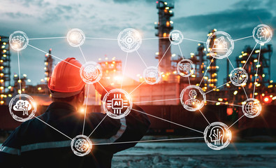 engineering man with safety helmet standing at smart factory background against oil refinery plant in heavy petrochemical industrial estate - Image