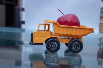 an apple on a toy truck