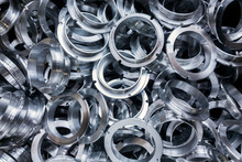 A Batch Of Machined Shiny Metal Parts With Selective Focus