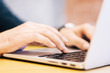 © Who is Danny - Sideview of male using laptop on desktop
