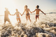 © simona - Defocused for active and motion concept people have fun running in the sea water during summer vacation - group friends together enjoy happiness - action caucasian men and women in friendship