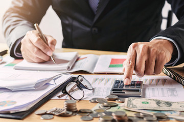 Fototapete - businessman working in office using calculator for calculate budget money