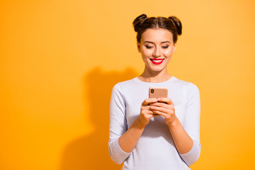 Canvas Print - Social media marketing concept. Portrait of cute beautiful female student receiving emails from sweeteheart reading news feed dressed in light jumper over bright background 