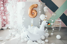 Birthday Photo Zone With White Balloons And Inflatable Giant White Swan. Golden Number 6 Six Made Of Inflatable Balloon. Balloons Decor.