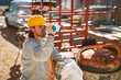© astrosystem - Construction worker on a heavy site doing hard work and drinking water.