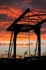 Wall Mural - silhouette of a drawbridge in holland against a fiery red sky.