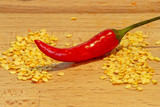 Fototapeta  - Chili pepper in-between two piles of seeds