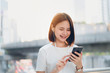 © sitthiphong - Women are listening to music from white headphones. And using hands touch to use various functions, happy mood.