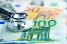 Stethoscope On US Dollar And Euro Banknotes, Finance, Account, Statistics, Analytic Research Data And Business Company  Medical Health Meeting Concept