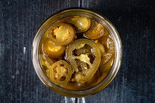 Homemade Spicy Jalapeno Pepper Marinated And Sliced In A Glass Bowl On A Dark Wooden Background