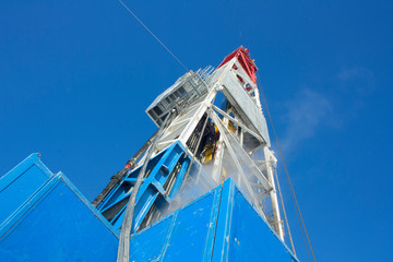 Wall Mural - Drilling rig in Siberia bottom-up view. Winter.