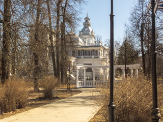 Wall Mural - Beautiful white building in the old style. Early spring. The sun is shining