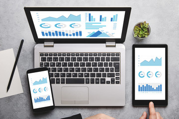 graphs and charts elements on laptop, tablet and smartphone screen