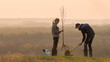 © StockMediaSeller - Woman with adult son planting a tree