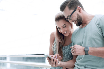 close up.a couple in love discussing video on a smartphone