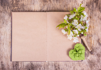 Wall Mural - Open blank book. White flowers and heart. Cherry flowers. Origami heart