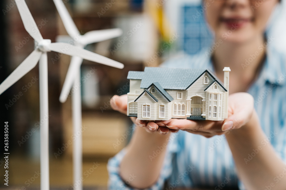 focus on female architect hands holding on new 3d house miniature model ...