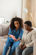 © zinkevych - Pleasant curly nurse showing online news to elderly lady