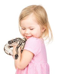 Smiling little girl playing with a python in her arms. Isolated on white background