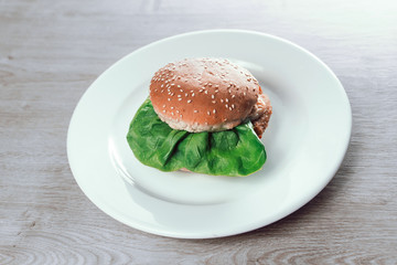 Wall Mural - meat hamburger on white plate on wooden background