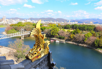 Wall Mural - Golden dragon fish statue (Shachihoko) on Okayama castle roof, Okayama, Japan