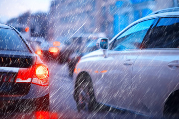 Wall Mural - blurred background autumn auto rain on the road / night lights and raindrops in the autumn traffic jam on the road, urban style traffic