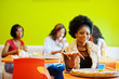 © AS Photo Family - African woman with pizza sitting at restaurant against dark skinned girls.