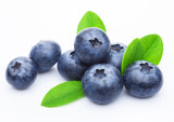 Fototapeta  - Fresh raw organic blueberries with leaf on white background. Macro close up
