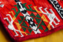 Ethnic Patterned Red Saddlebag Sack On Wooden Background Close Up View