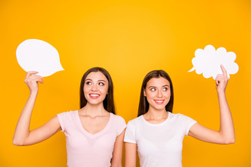 Poster - Portrait of nice-looking cute charming lovely winsome attractive cheerful cheery straight-haired girls holding in hands empty clouds isolated over bright vivid shine yellow background