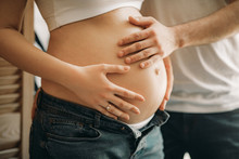 A Man Touches Of The Belly Of His Pregnant Wife.