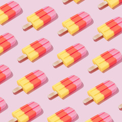 Colorful Ice cream popsicle pattern on pastel pink background. Minimal summer concept. Flat lay.
