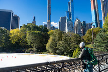 Man Looking At Empty Ice Rink At Central Park In Winter
