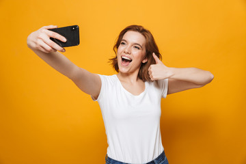 Wall Mural - Portrait of a happy lovely girl standing isolated