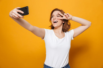 Poster - Portrait of a happy lovely girl standing isolated