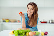 © deagreez - Portrait of her she nice lovely charming cute attractive cheerful cheery glad positive brown-haired lady holding in hand tomato mix vegs in light white interior style kitchen