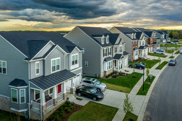 Aerial view of typical American new construction neighborhood street in Maryland for the upper middle class, single family homes USA real estate with dramatic sky