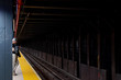 © Stuart Holmes - A lone 20 something millennial waits on a subway platform late at night while looking intently at his phone