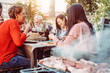 © Alessandro Biascioli - Happy family eating and drinking wine at barbecue dinner in the garden - People with different ages dining together at bbq lunch - Concept of food and drink