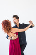© satura_ - Social dance, bachata, kizomba, people concept - Young pretty woman in pink dress and man dancing waltz or salsa