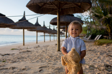 Sticker - Happy beautiful fashion kid, child, casually dressed, enjoying the sunrise on the beach in Mauritius