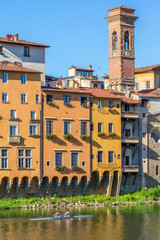 Canvas Print - Apartment building located on the river with a rowing boat