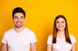 © deagreez - Close up photo two amazing beautiful she her he him his couple standing side by side look each other did trick funky childish mood wear casual white t-shirts outfit clothes isolated yellow background